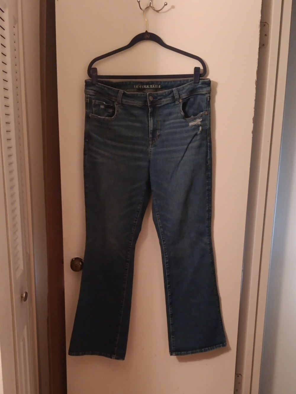 Next Level Low Rise Kick Boot Cut Jeans In Medium Blue with Subtle Distress